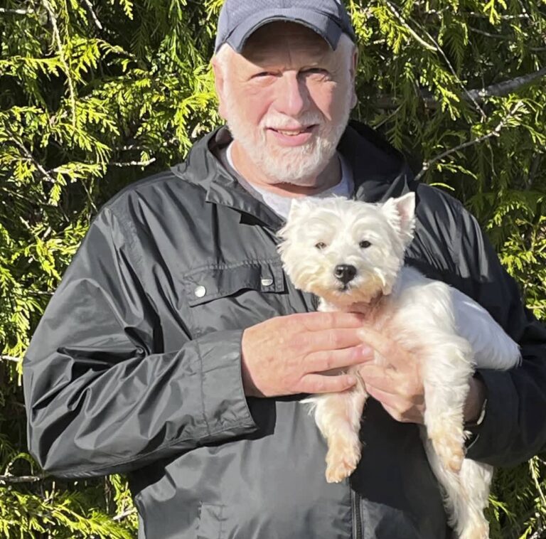 Joel Ackerman at home with their West Highland White Terrier